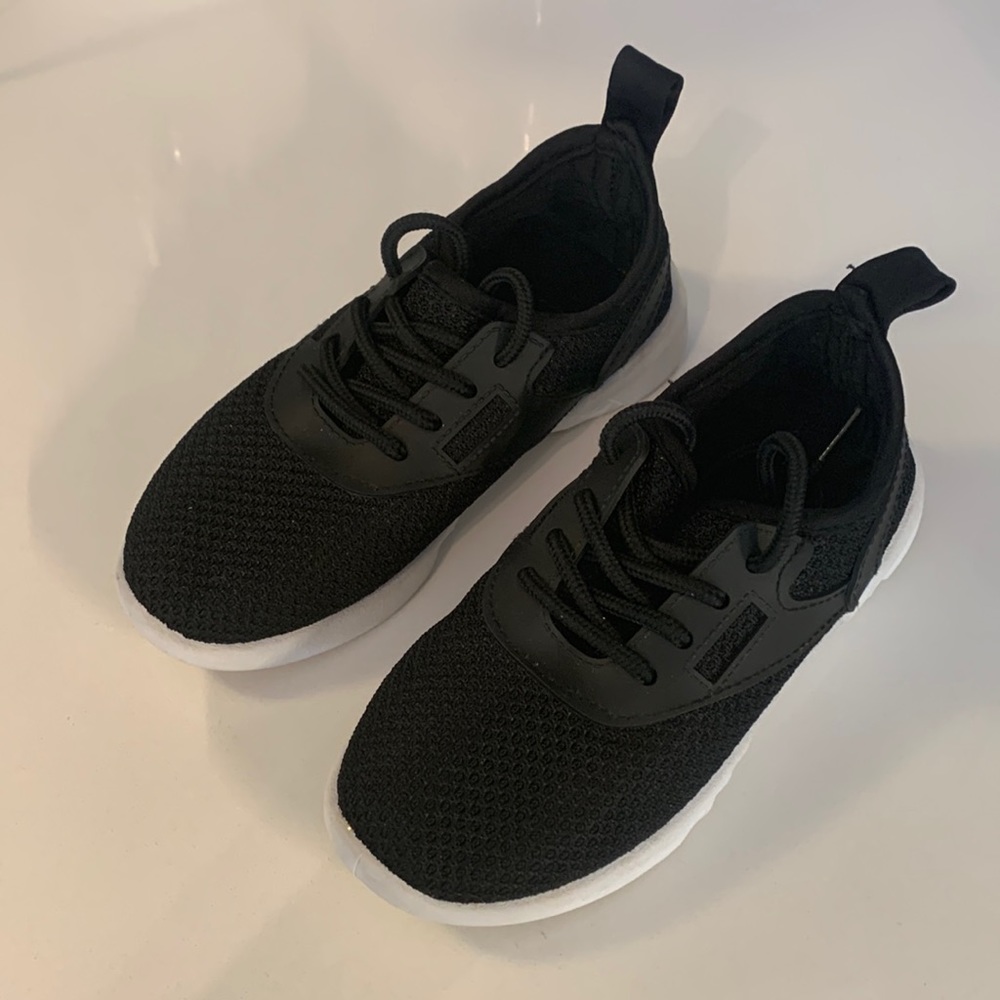 Gender neutral black and white athletic shoes